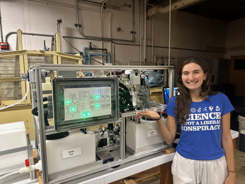 Camille Brulé, a PhD student in Prof. Nelson's research group, with wastewater equipment (Photo by Sophia Safa)